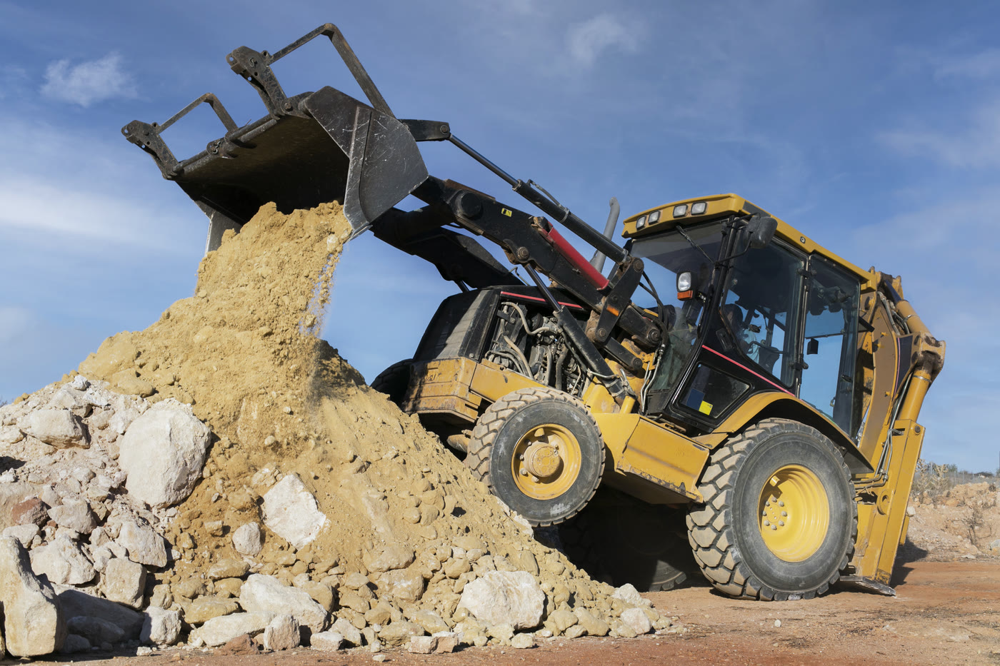 Vertex backhoe loader working an excavation pit