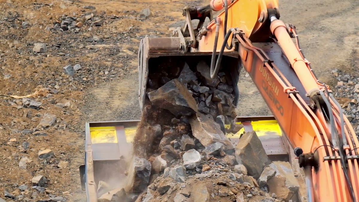 Vertex excavator loading broken rock into a haul truck